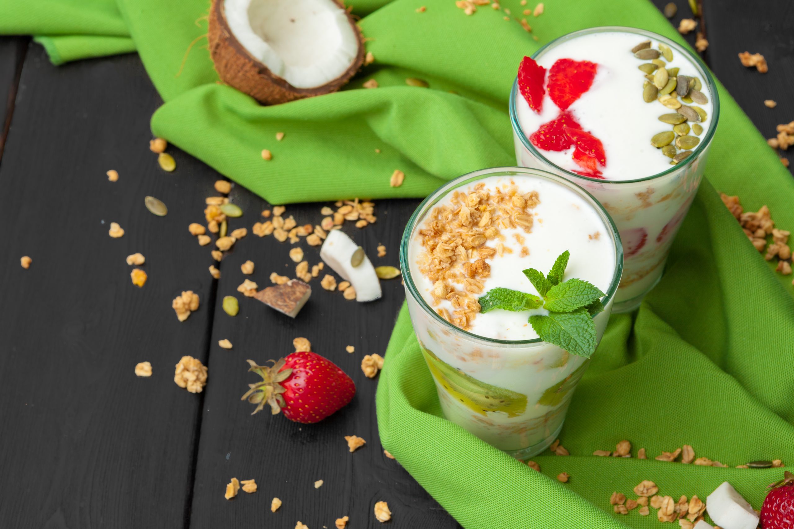 Home-made Yoghurt with granola fruit and coconut top view on wooden background - Α2Z Nutrition
